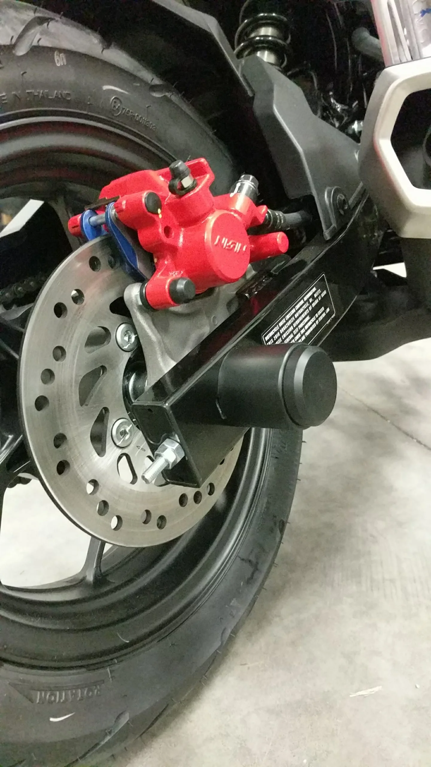 Axle slider on rear of honda grom motorcycle from Outlaw stunt parts